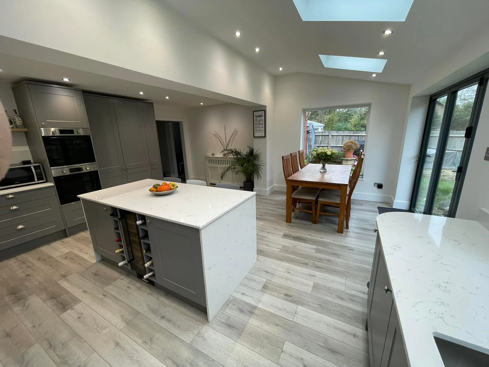 A kitchen with a center island and a dining table.