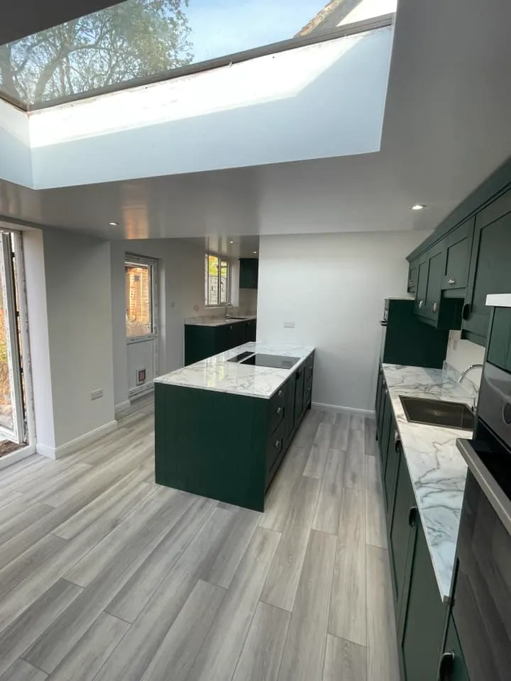A large kitchen with a skylight above it.
