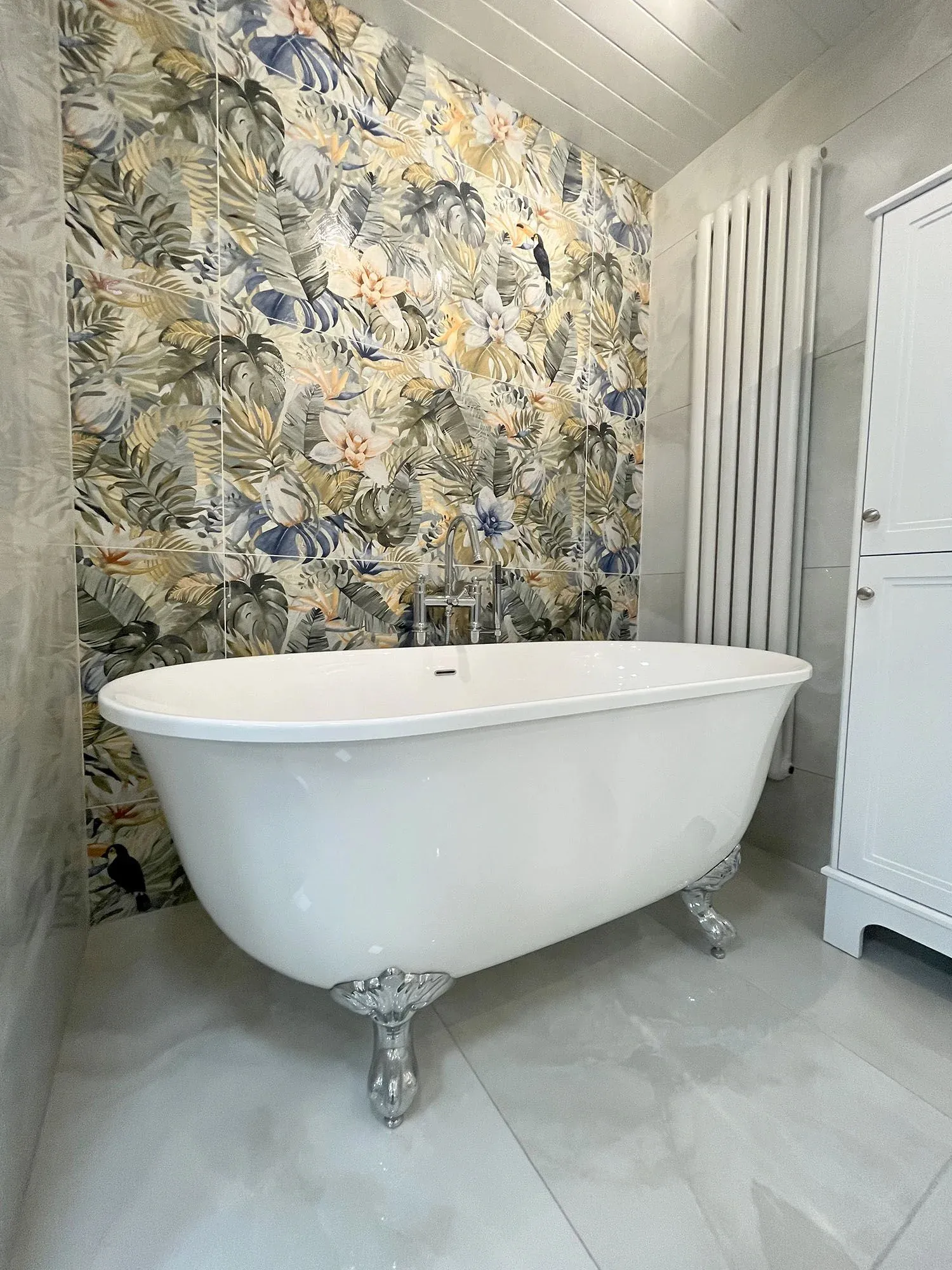 A white bath tub sitting next to a white cabinet.
