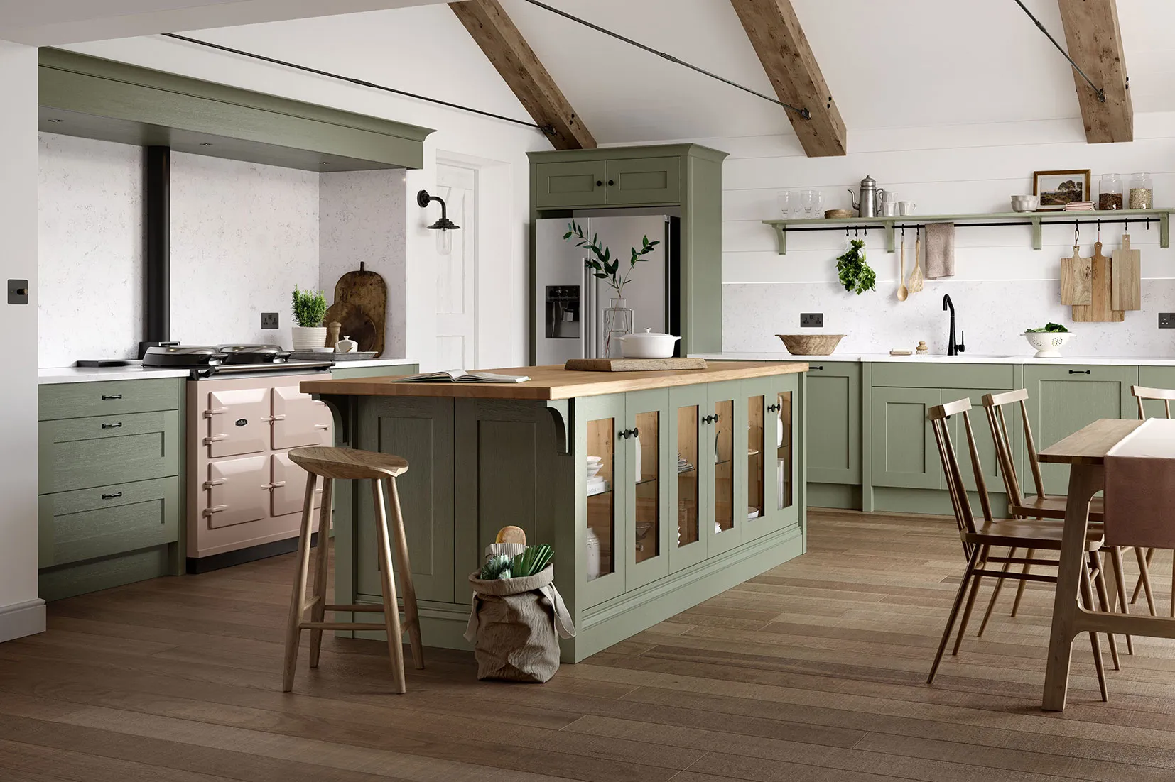 A kitchen with green cabinets and wooden floors.