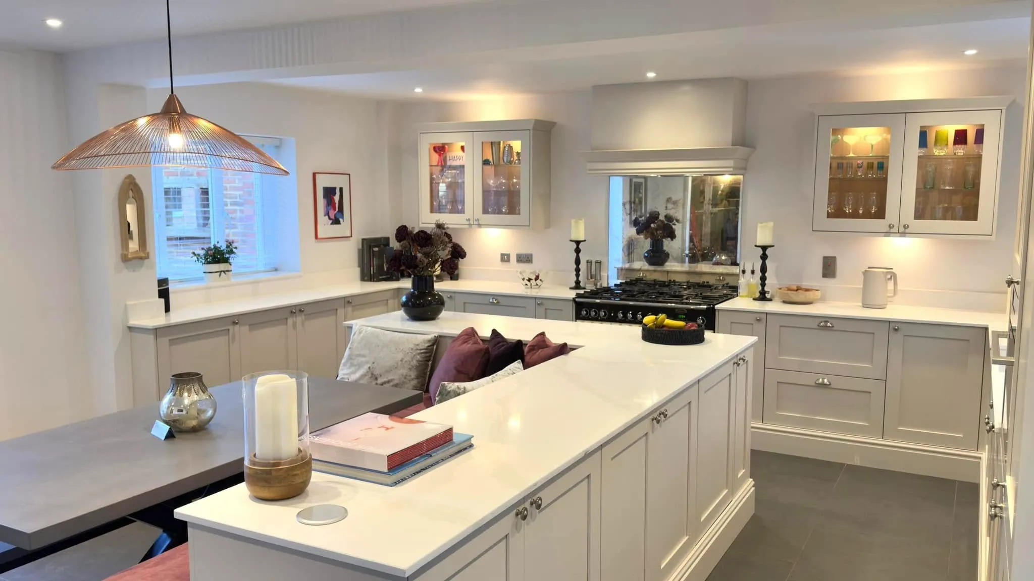 A large kitchen with a center island and a stove top oven.