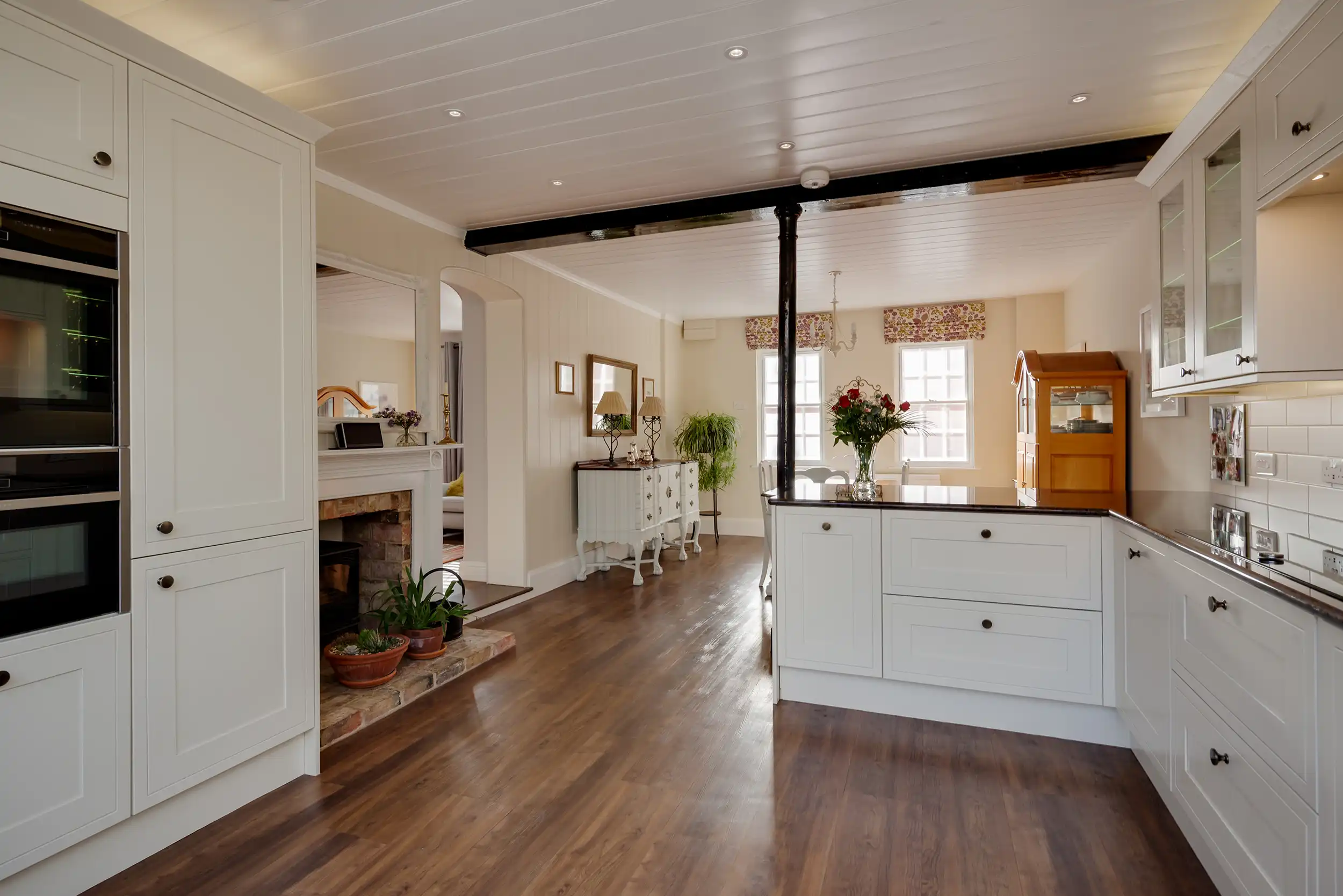 Kitchen with wooden flooring and metal rsj.